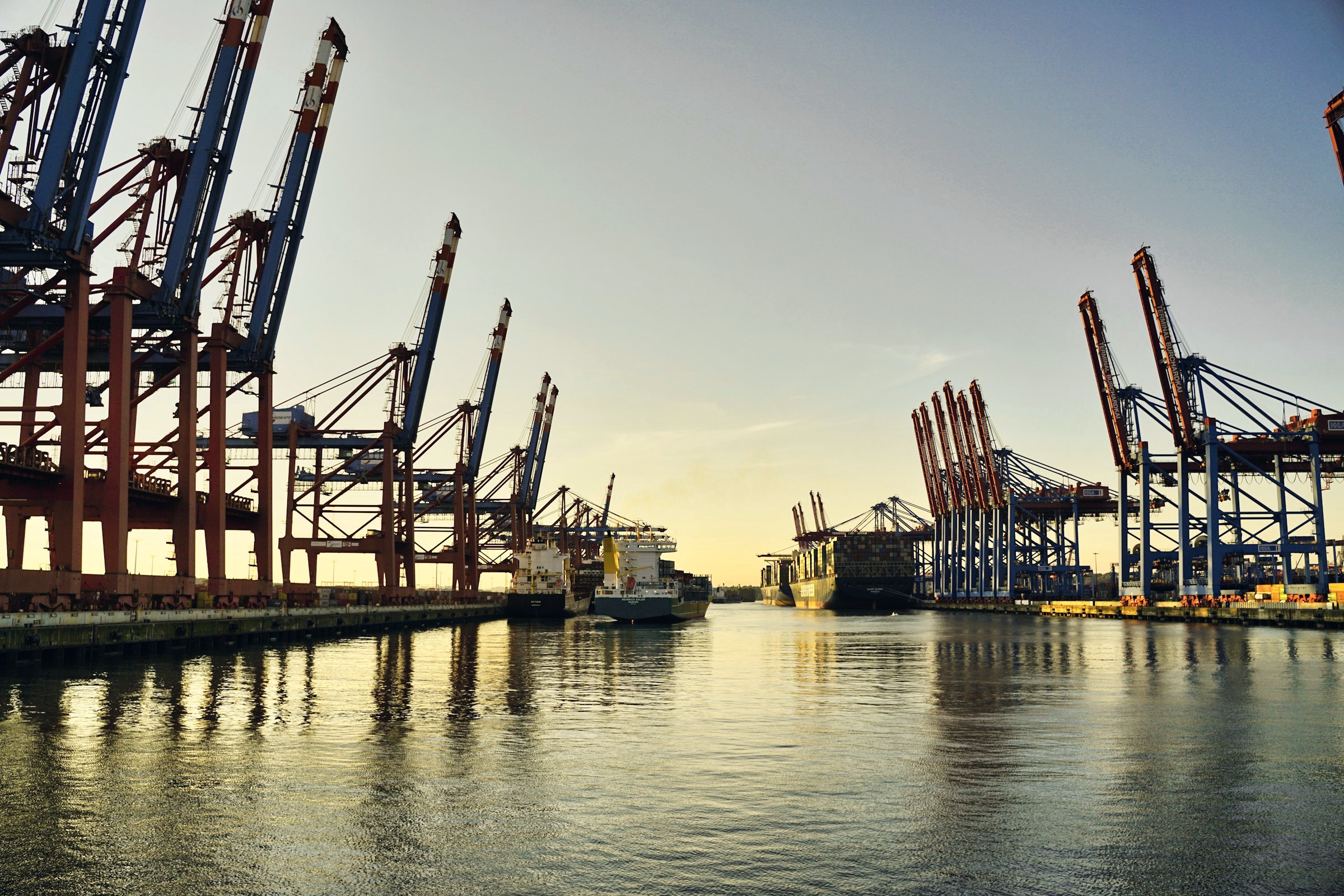 Container cranes at a port at sunset