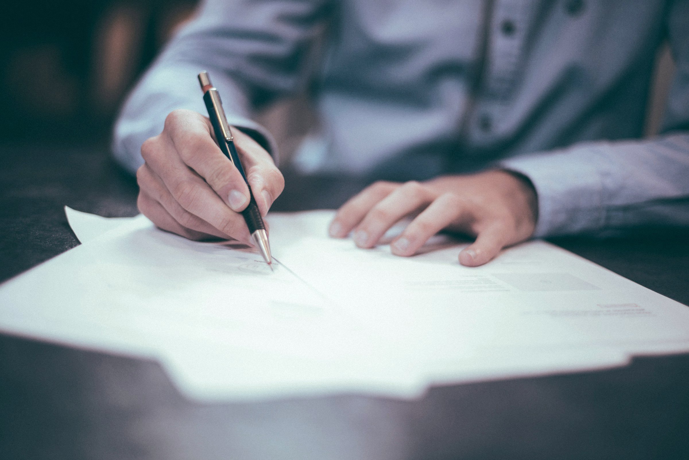 Hand signing a document