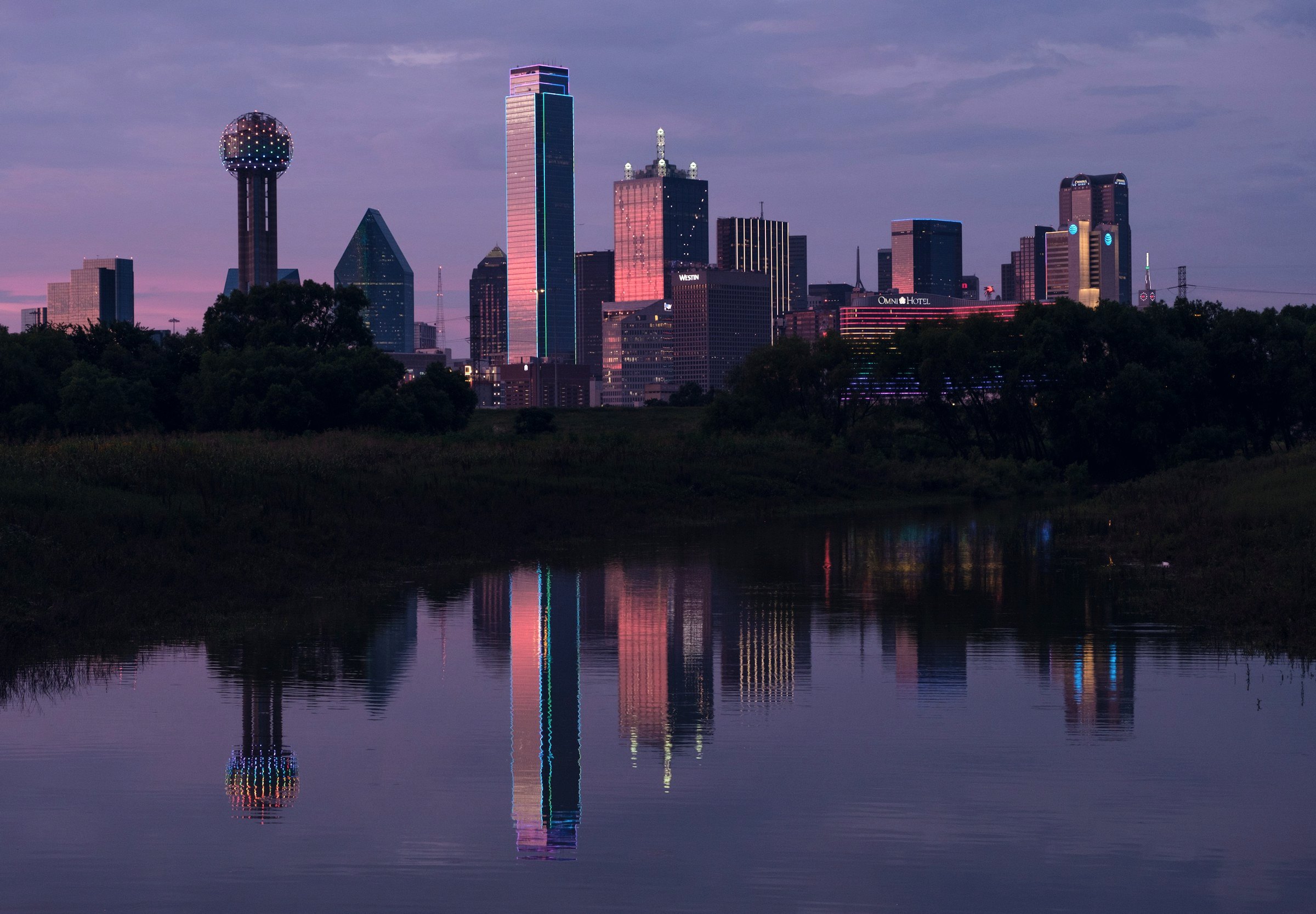 Dallas skyline reflected in water at dusk