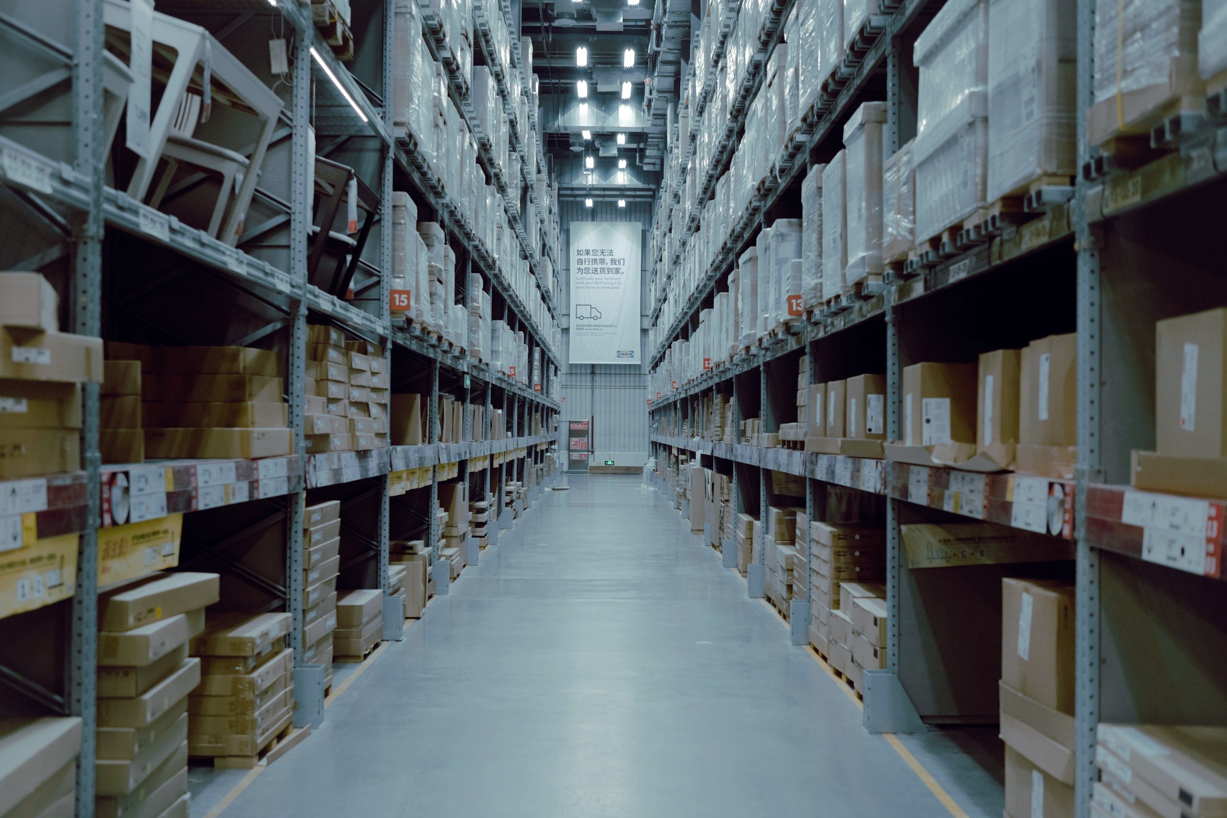 Warehouse aisle between tall shelves