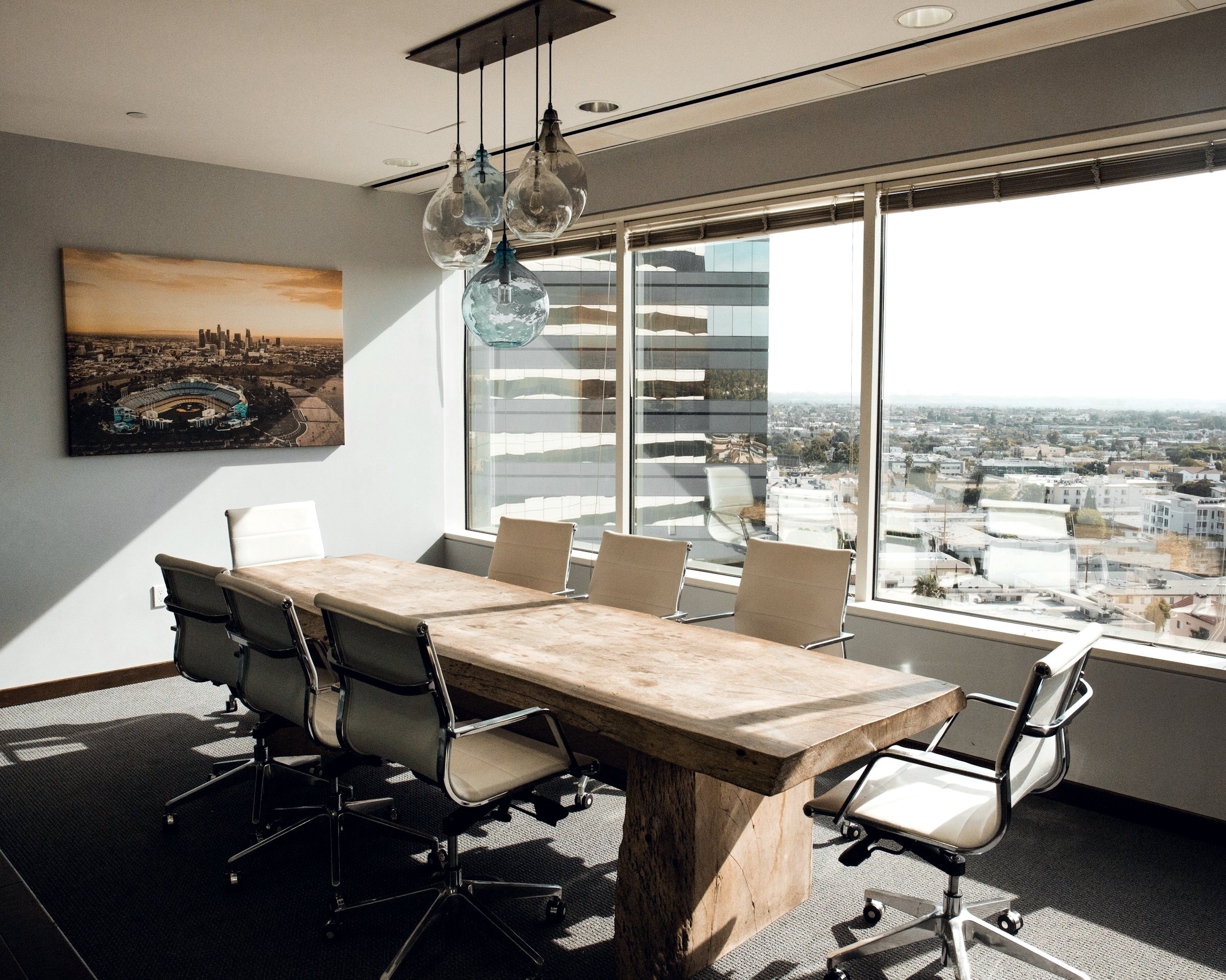 Conference room with a long wooden table and a city view